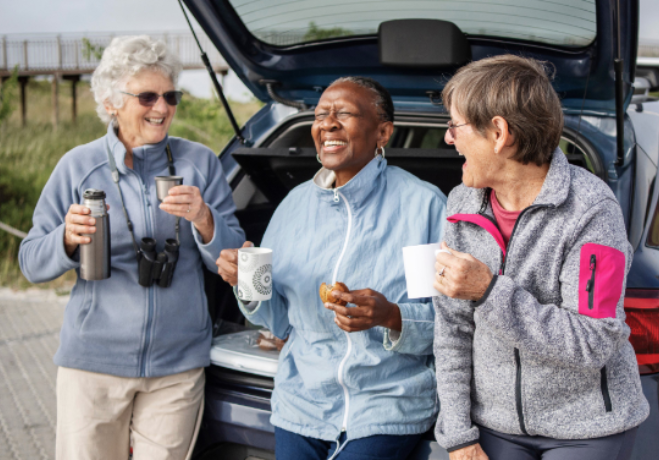3-ladies-drinking-coffee-infront-of-car