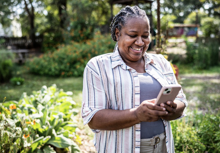 woman-smiling-and-looking-at-phone